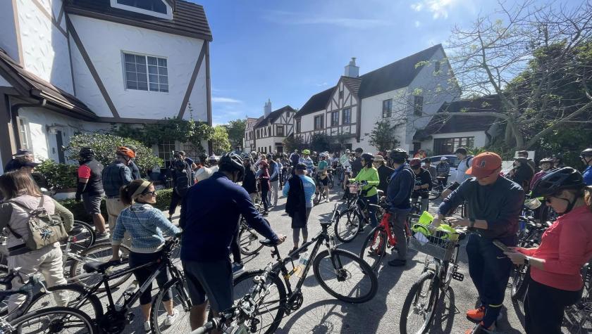 Wide angle lens view of cyclists under sunny day outside the French Normandy villages