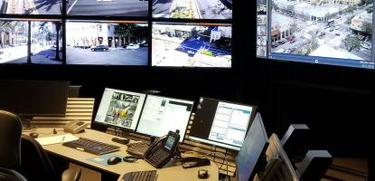Control room with several monitors. Desk with monitors and phones