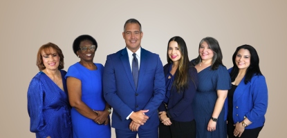 City Clerk office staff all in blue professional clothing in a beige background
